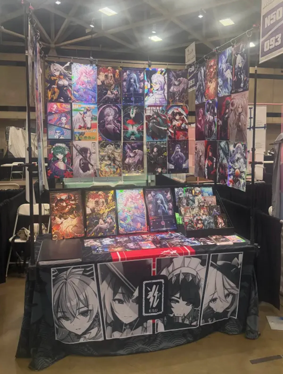 Booth setup with hanging prints and table banner