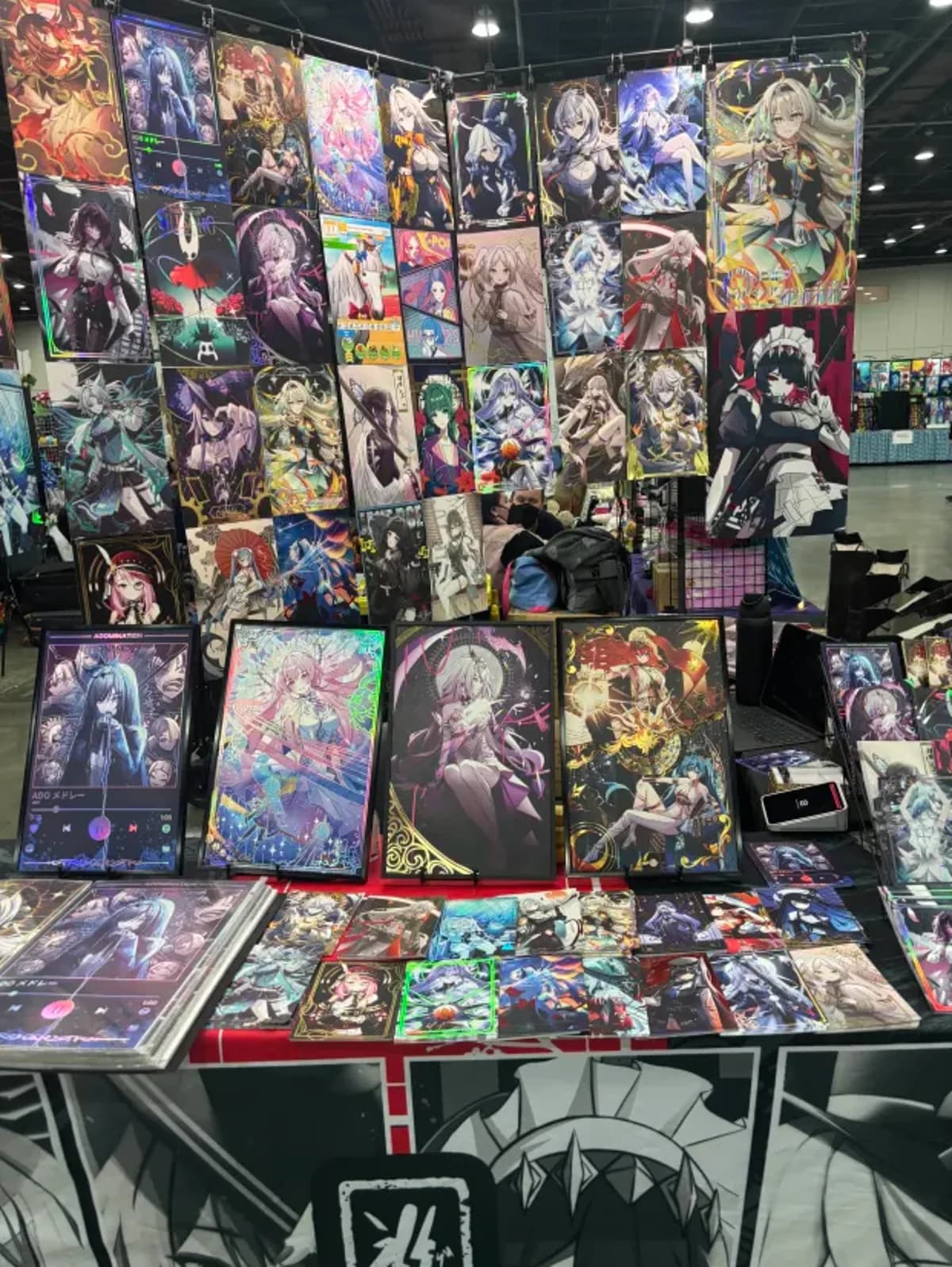 Booth table stacked with framed prints